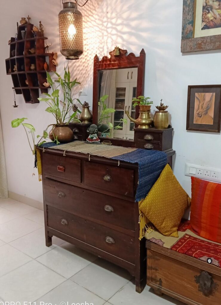 Lit lamps and warm colours, beautiful antiques at the living space area| Leesha's Pune home| Thekeybunch