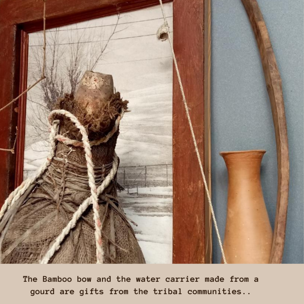 The bamboo bow and the water carrier made from a gourd gifted by tribal communities | Leesha's Pune home | Thekeybunch