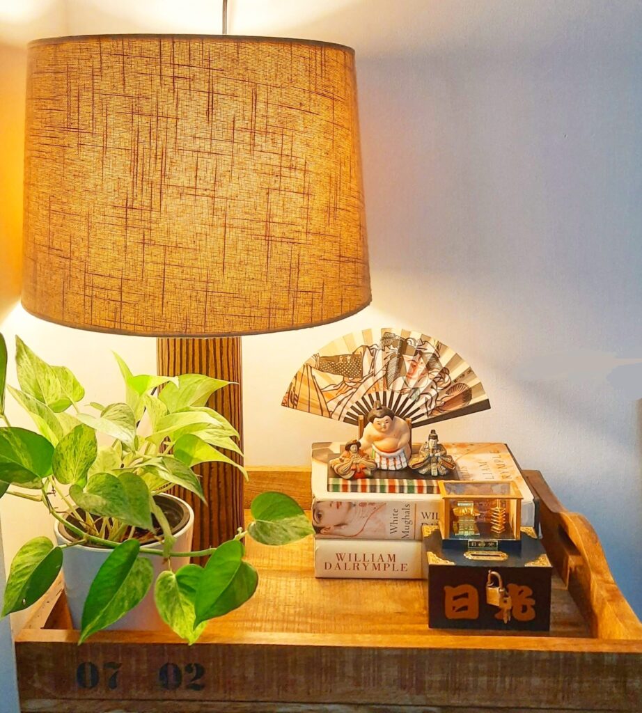 The apartment living room is decorated with beautiful vignette, green plant and table lamp on a wooden tray | Upasana Talukdar home tour | thekeybunch decor