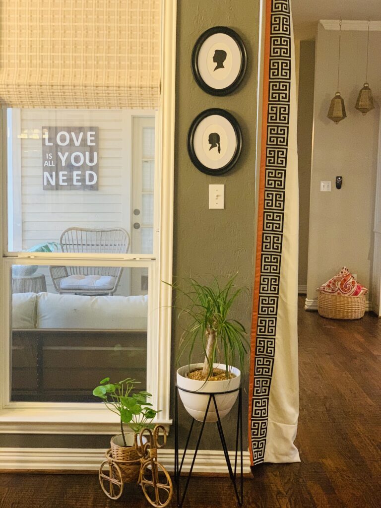 silhouette art, brass bell on the wall and green plants at the corner of the room  | Ruma's Indian Home in Texas | theKeybunch decor blog