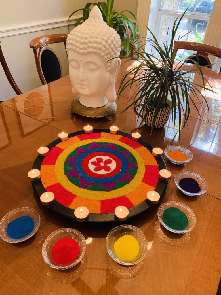 the colorful rangoli, candle glamour, buddha statue and green plants decorated at Indian festival | Ruma's Indian Home in Texas | theKeybunch decor blog