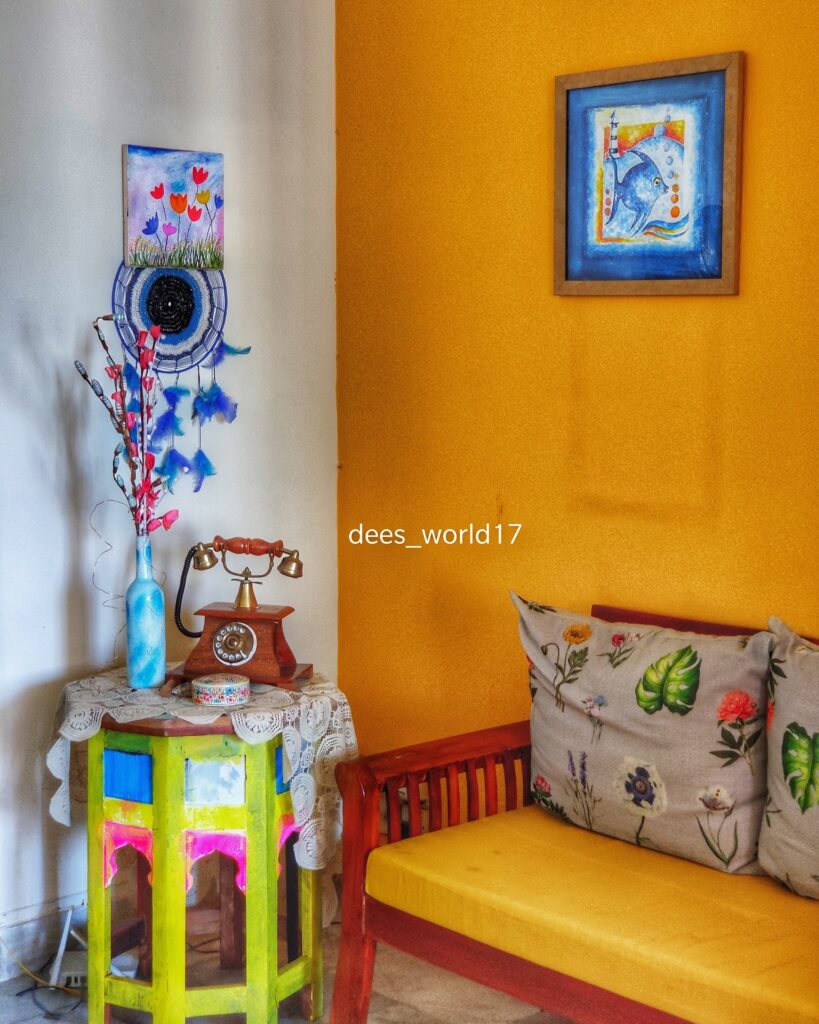 The corner of the room is decorated with old yellow tables, that have been given a new lease of life, with bright colours and artwork | Dharitri home tour | thekeybunch decor