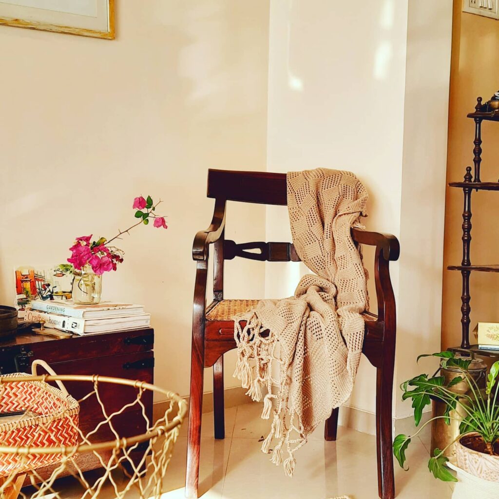 the gorgeous woolen throw, vintage chair, fresh flowers and green plants at the corner of the room - Decor trends 2021 for Indian homes | Thekeybunch decor blog