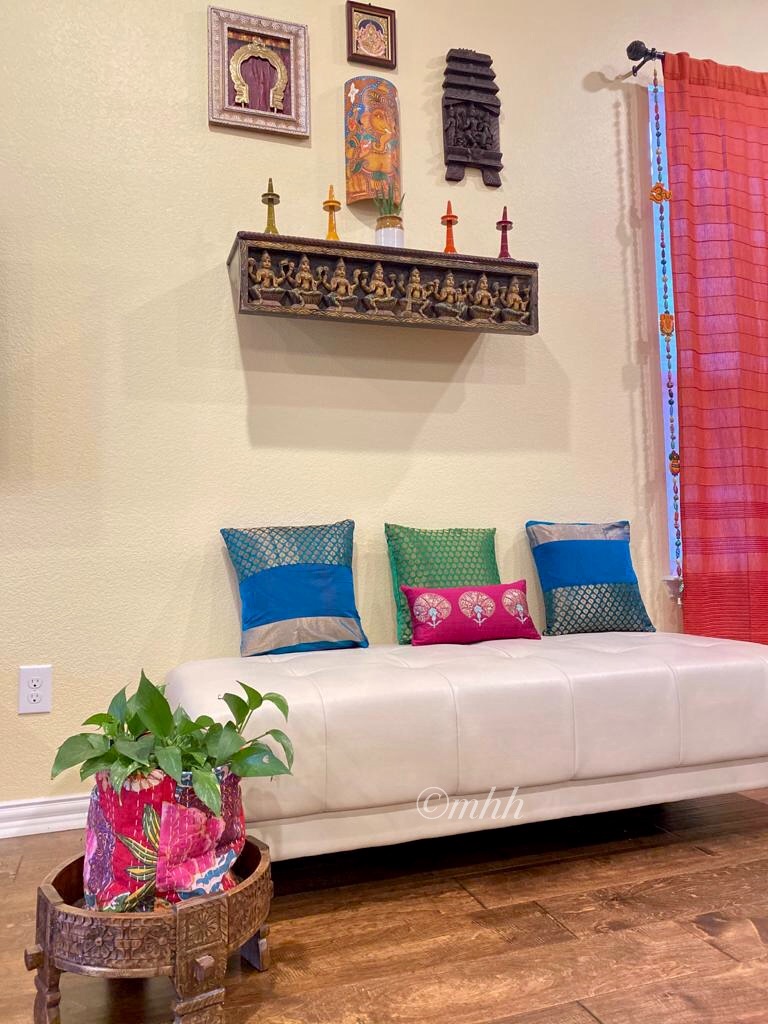 Home tour of Meena Harish | A Prabhavalli framed on a silk blouse fabric, Kerala mural Ganesha on a Bamboo bark, a carved kavadi & Lakshmi Tanjore painting adorn one of the walls