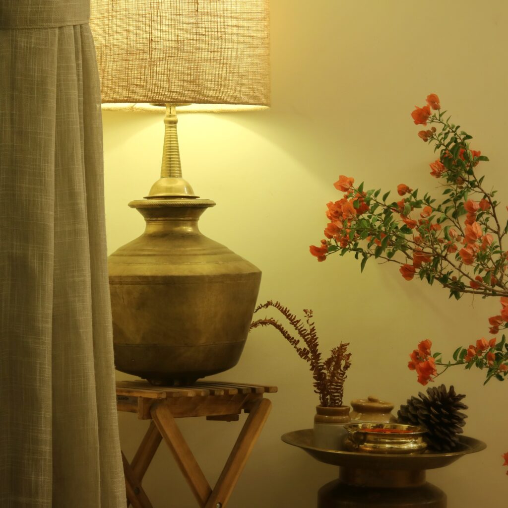 The ikea table, jute lampshade, fern fronds are all fairly contemporary and the brass elements are traditional. The bougainvillea is in bloom | Home Tour: A beautiful Antique Modern home in Bangalore