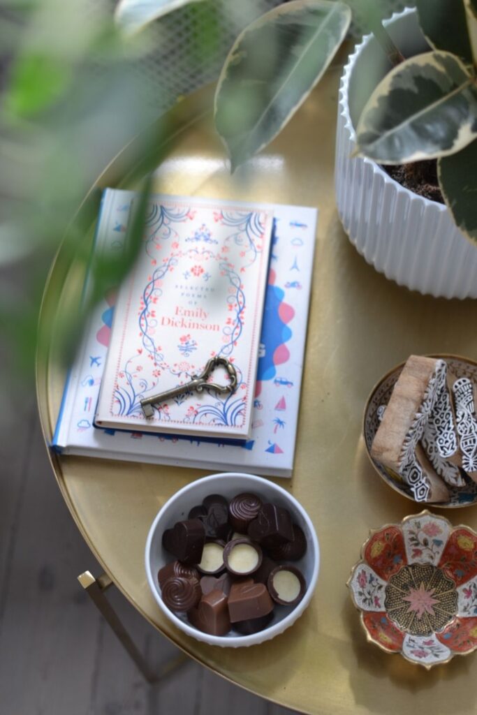 Books with brass key, chocolates and green plants on the table | Naina's Scandi-Minimalist Home with Indian Accents