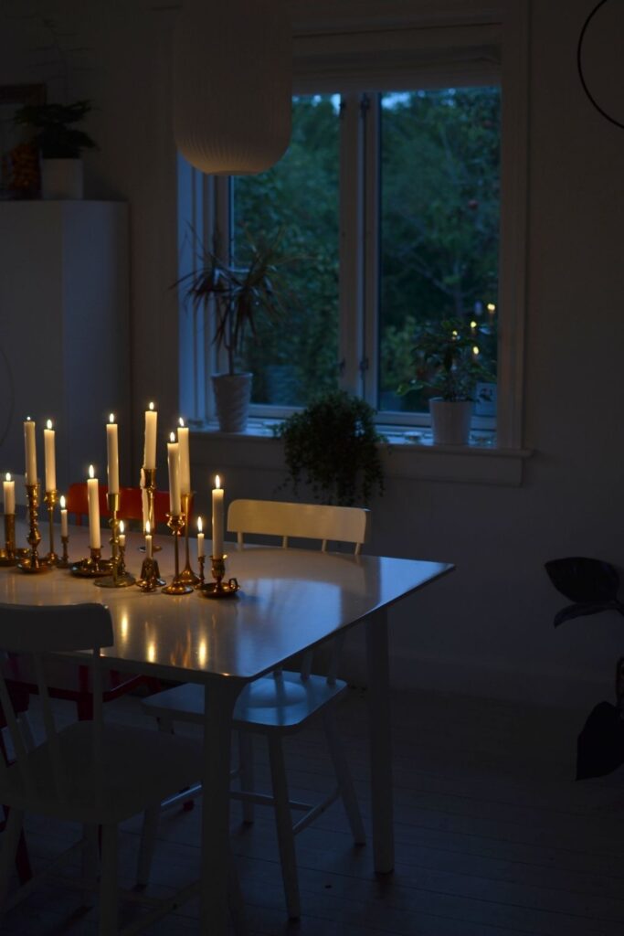 Lighting candles on the dining table | Naina's Scandi-Minimalist Home with Indian Accents