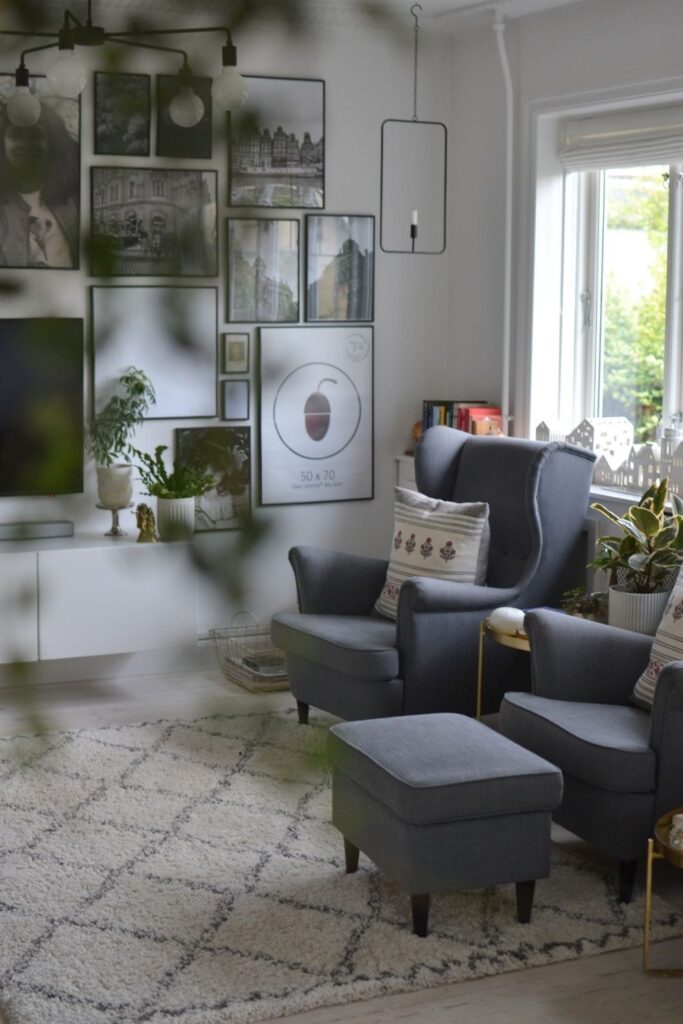 The beautiful frame of candle light hanging in a metal rectangle, grey chair and gallery wall | Naina's Scandi-Minimalist Home with Indian Accents