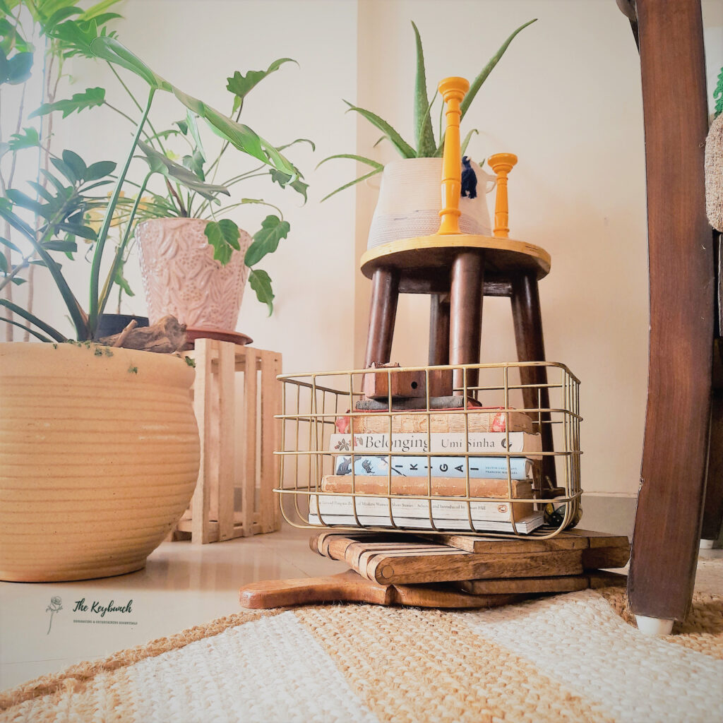 Decorate with a touch of yellow during the pandemic | a pair of candlestands in yellow, green plants and a collection of books makes the room bright and beautiful