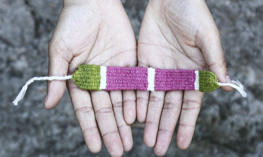 A closeup of a loom-woven wrist band | 6 Tapestry DIYs on Muezart's home-use loom