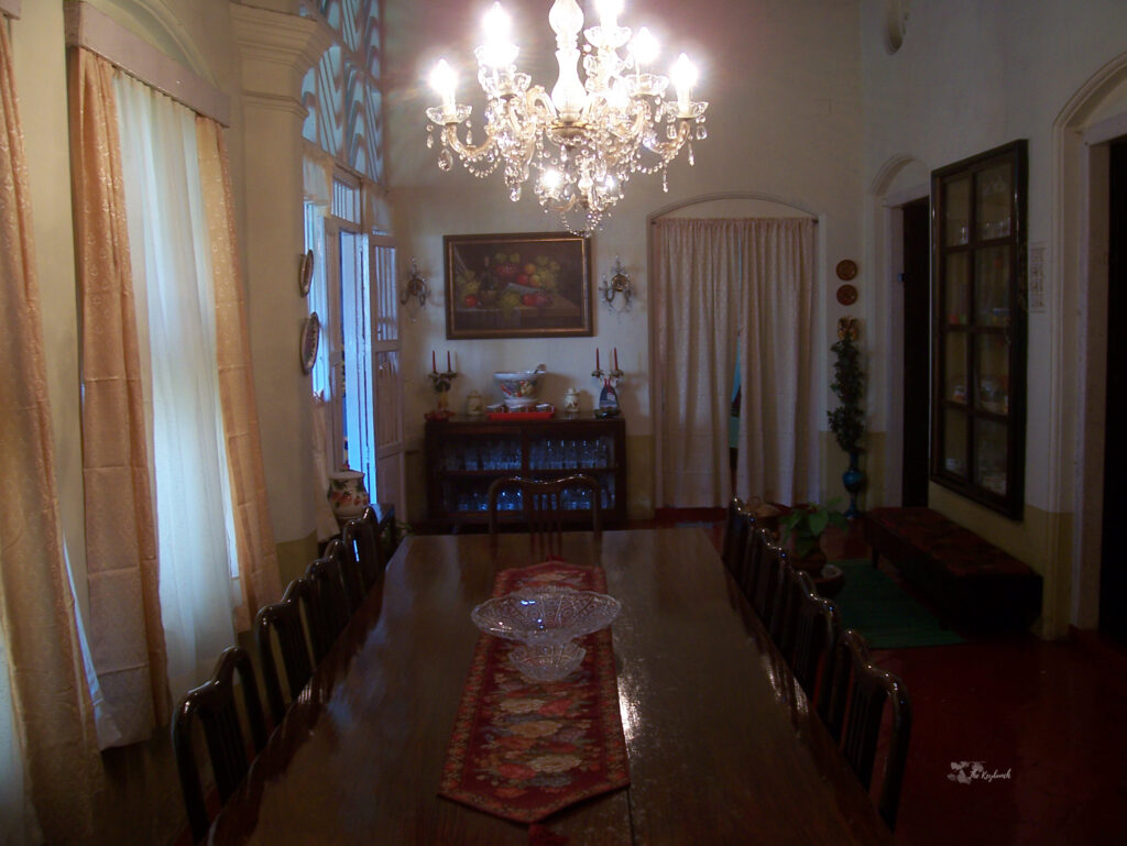 An enormous formal dining room, and the chandelier definitely steals the show | Belmont House in Mangalore, India | TheKeybunch decor blog