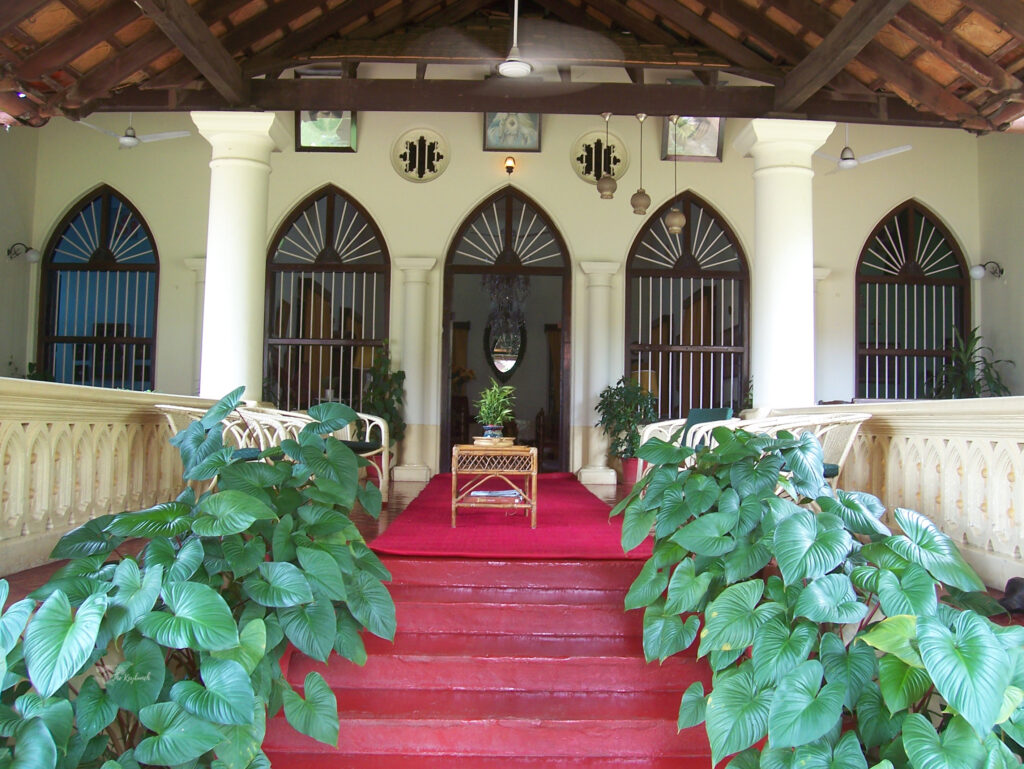 The attractive cathedral windows, green plants and the pillar of the main entrance door | Belmont House in Mangalore, India | TheKeybunch decor blog