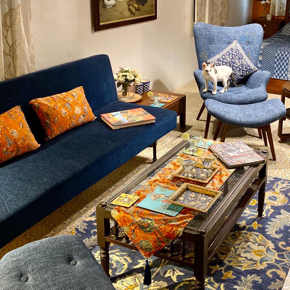 Villa Rashmi - A Heritage Gem in Mumbai | The private apartment was decorated with chairs, fresh flowers and books on the table | TheKeybunch decor blog