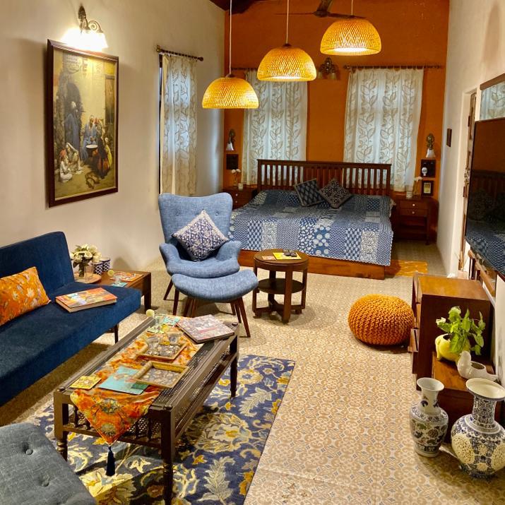Villa Rashmi - A Heritage Gem in Mumbai | The private apartment was decorated with chairs, fresh flowers, books on the table and bed for relaxing | TheKeybunch decor blog
