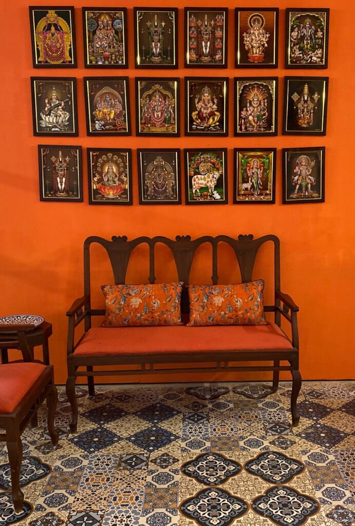 Villa Rashmi - A Heritage Gem in Mumbai | The wall frames of various hindu gods and italian mosaic tile at the room | TheKeybunch decor blog
