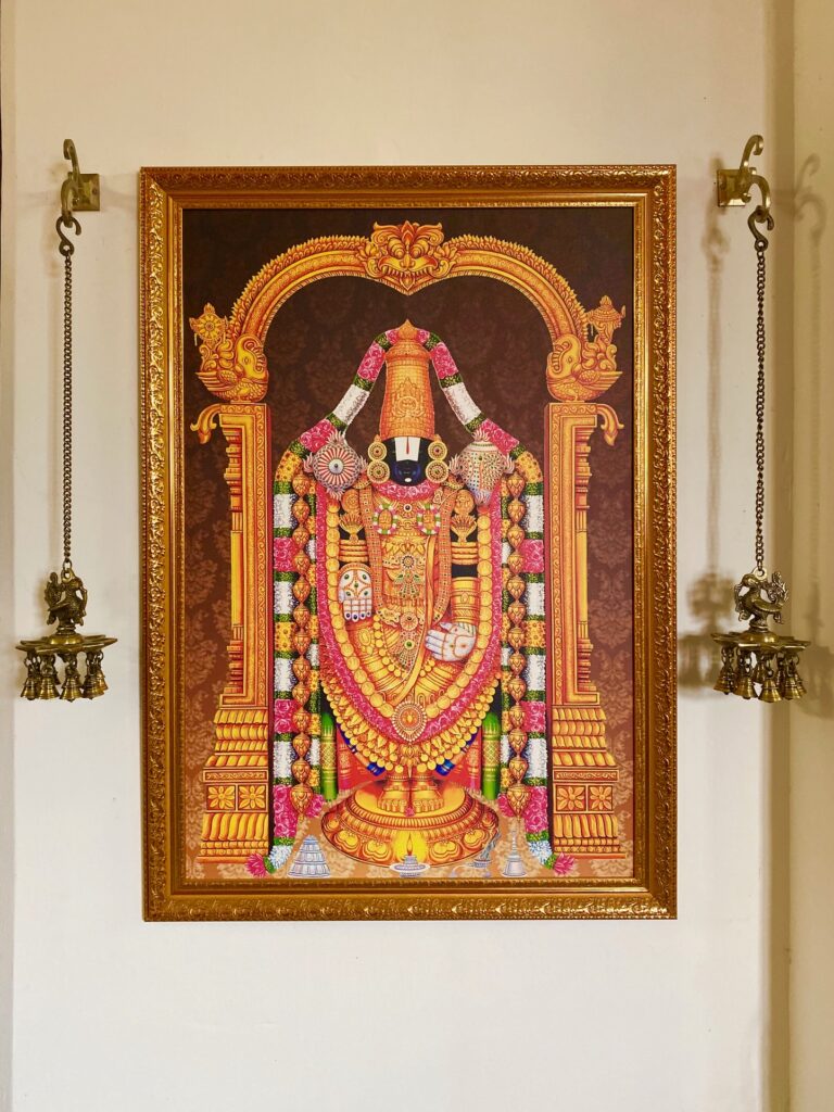 Villa Rashmi - A Heritage Gem in Mumbai | Hanging brass diya lamp and hindu god frame at corner of the room | TheKeybunch decor blog