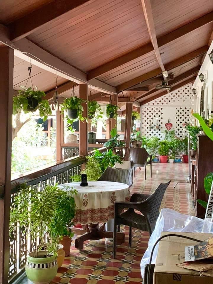 Villa Rashmi - A Heritage Gem in Mumbai | The green plants with rattan chair at the balcony | TheKeybunch decor blog