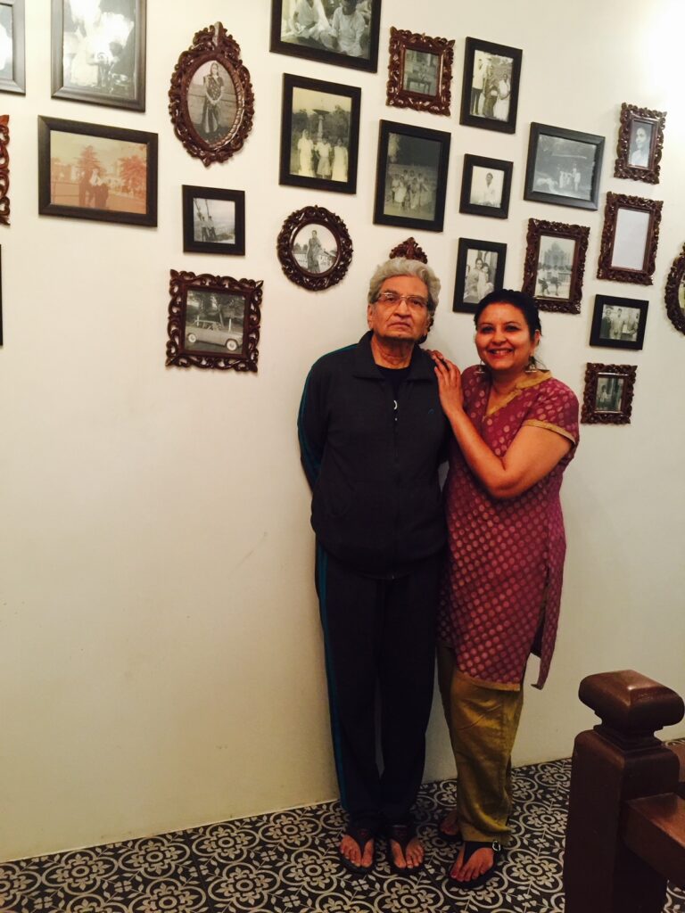 Villa Rashmi - A Heritage Gem in Mumbai | Deval Patel with her dad Haresh Patel in front of the old family photographs | TheKeybunch decor blog