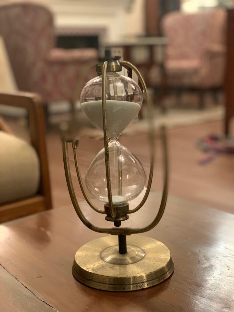 Villa Rashmi - A Heritage Gem in Mumbai | Vintage brass clock sand timer at the living room | TheKeybunch decor blog