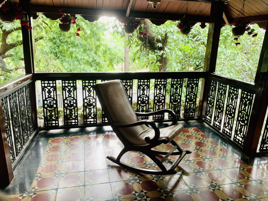 Villa Rashmi - A Heritage Gem in Mumbai | Old wooden rocking chair on the balcony of the house | TheKeybunch decor blog