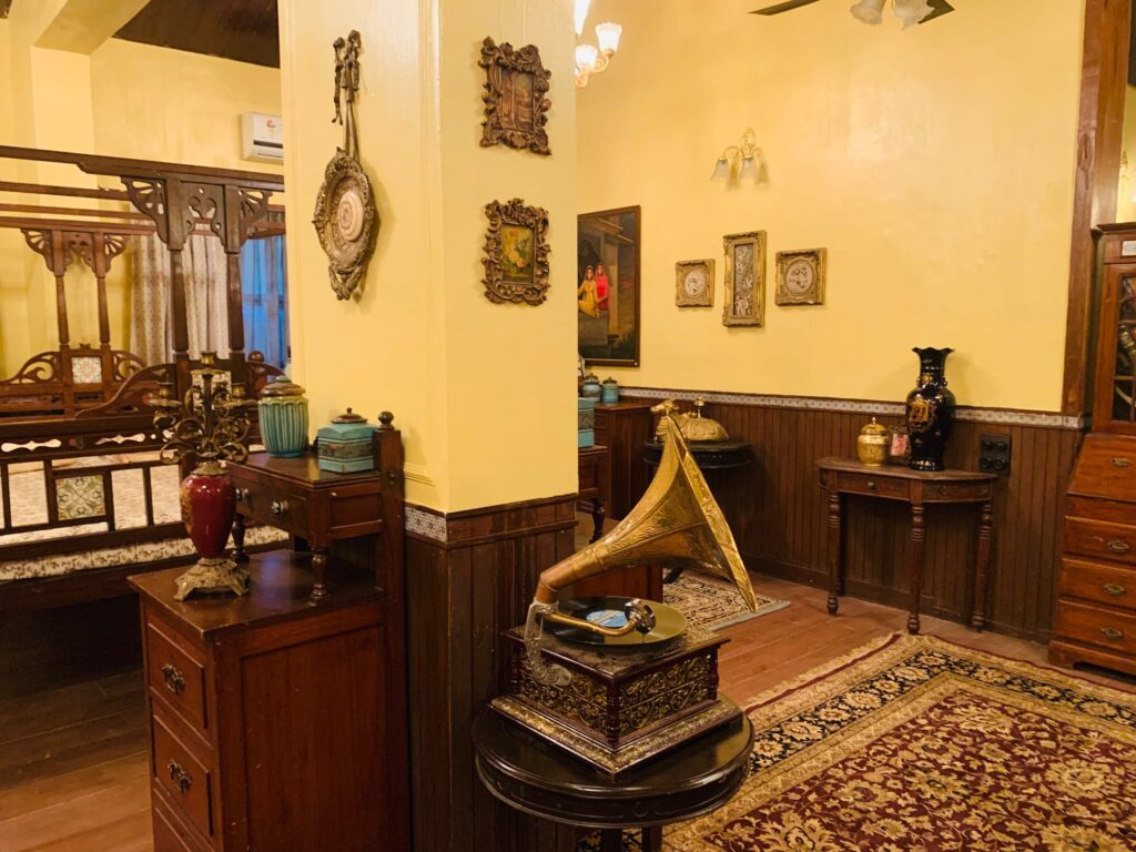 Villa Rashmi - A Heritage Gem in Mumbai | Gramophone music player with brass wall decoration at the bedroom corner | TheKeybunch decor blog