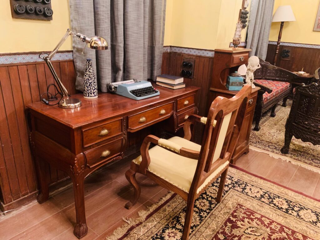 Villa Rashmi - A Heritage Gem in Mumbai | Typywriter, table lamp and book on top of console table at the corner of the bedroom | TheKeybunch decor blog