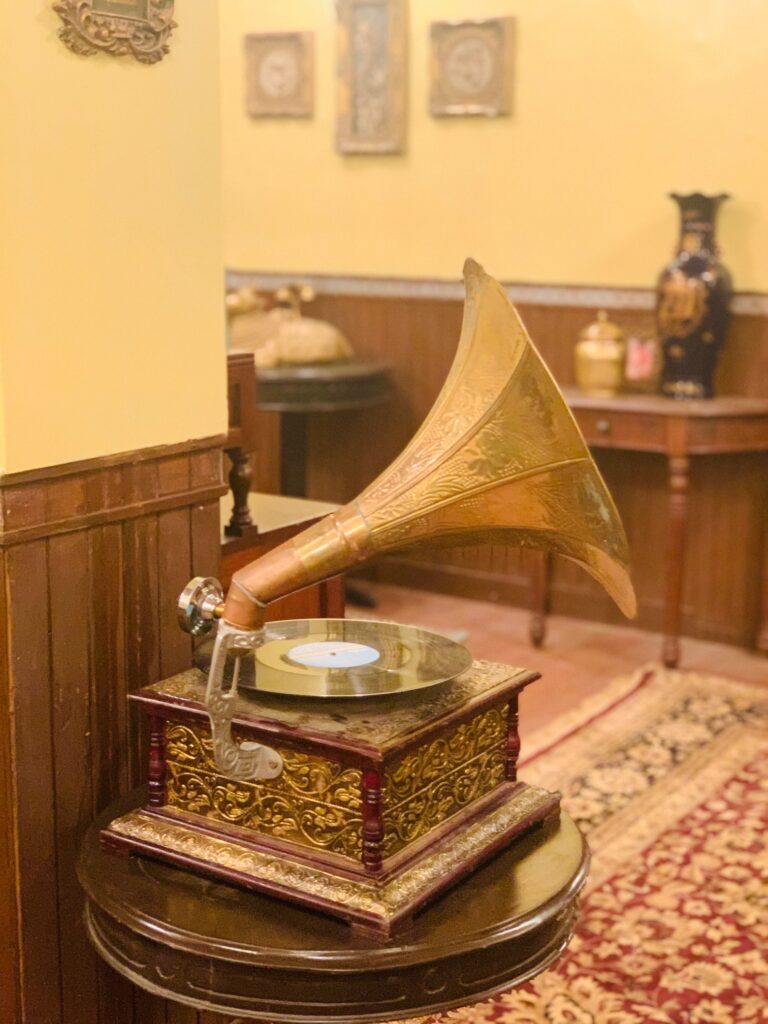 Villa Rashmi - A Heritage Gem in Mumbai | Brass gramophone music player on top of table at the bedroom corner | TheKeybunch decor blog