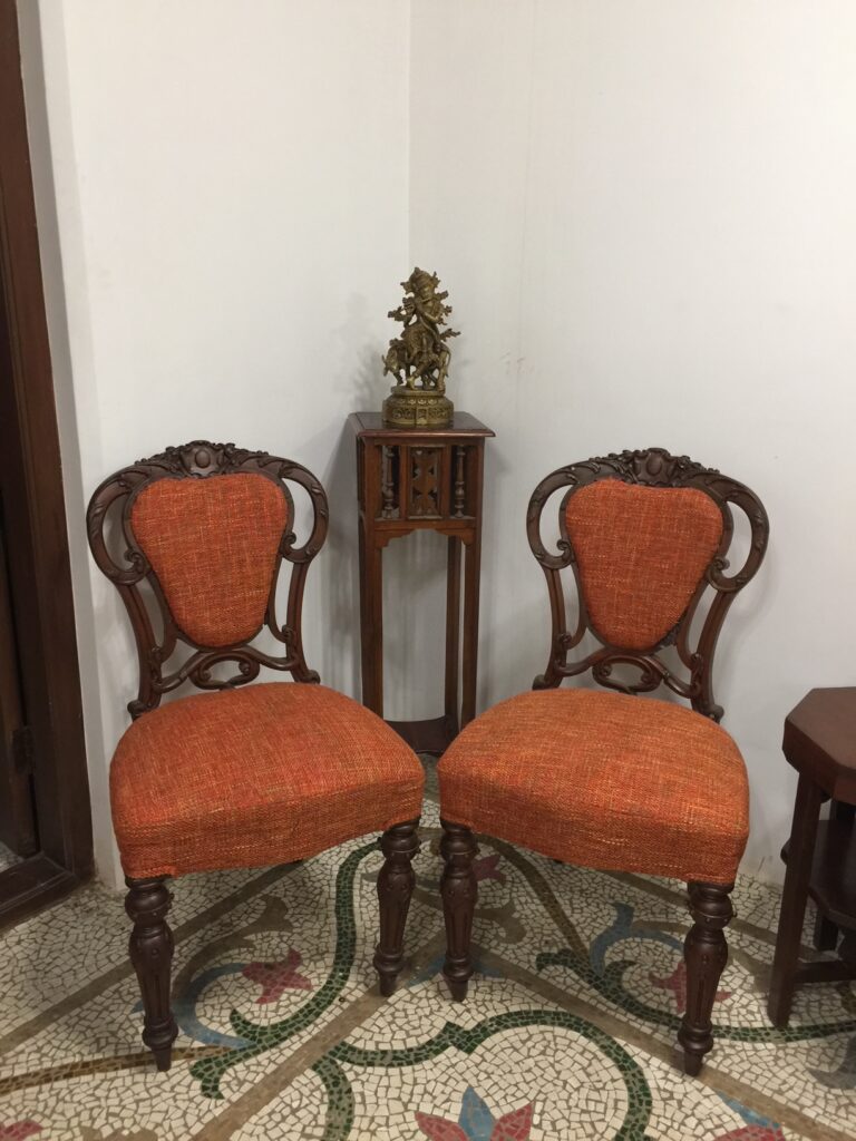 Villa Rashmi - A Heritage Gem in Mumbai | Antique chairs and brass idol on top of the table | TheKeybunch decor blog