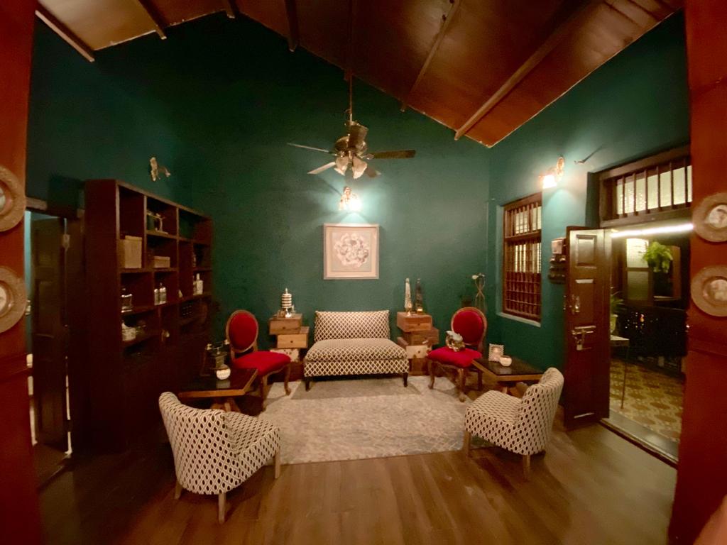 Villa Rashmi - A Heritage Gem in Mumbai | The living area was decorated with chairs, wooden shelf and wall frame | TheKeybunch decor blog