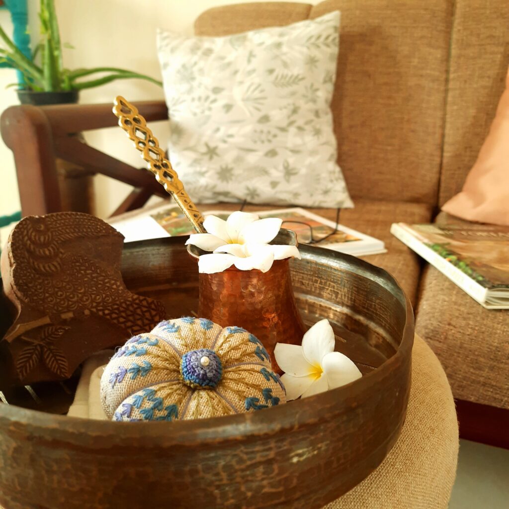Fall Decor in India - Autumn Season | The beautiful embroidered pieces in brass trays at center table in the living room