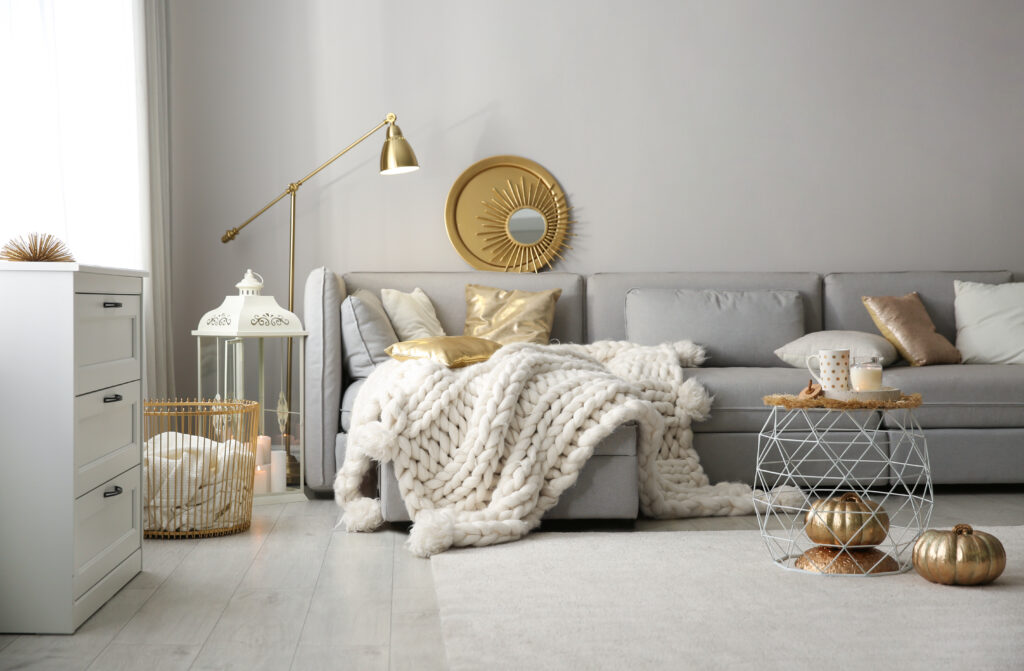 Decor Trends for 2022 | Cozy living room interior with knitted blanket on comfortable sofa