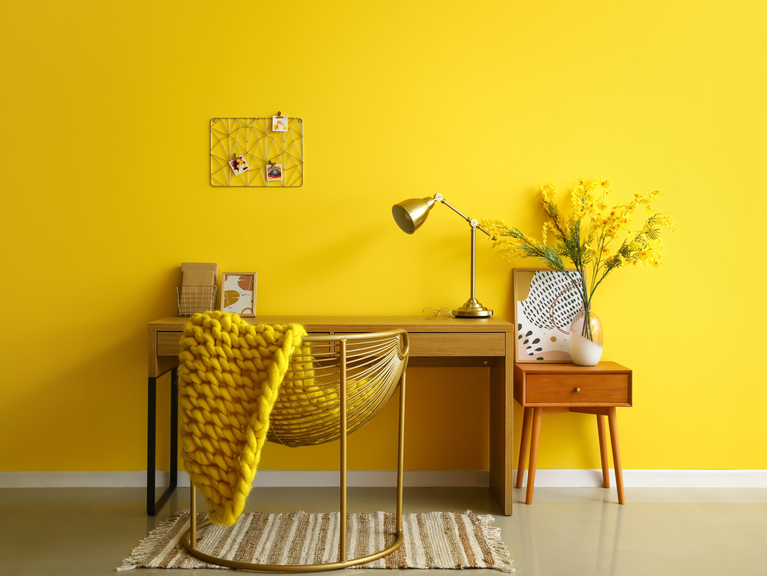 Decor Trends for 2022 | Interior of stylish office with modern workplace, golden lamp and yellow wall