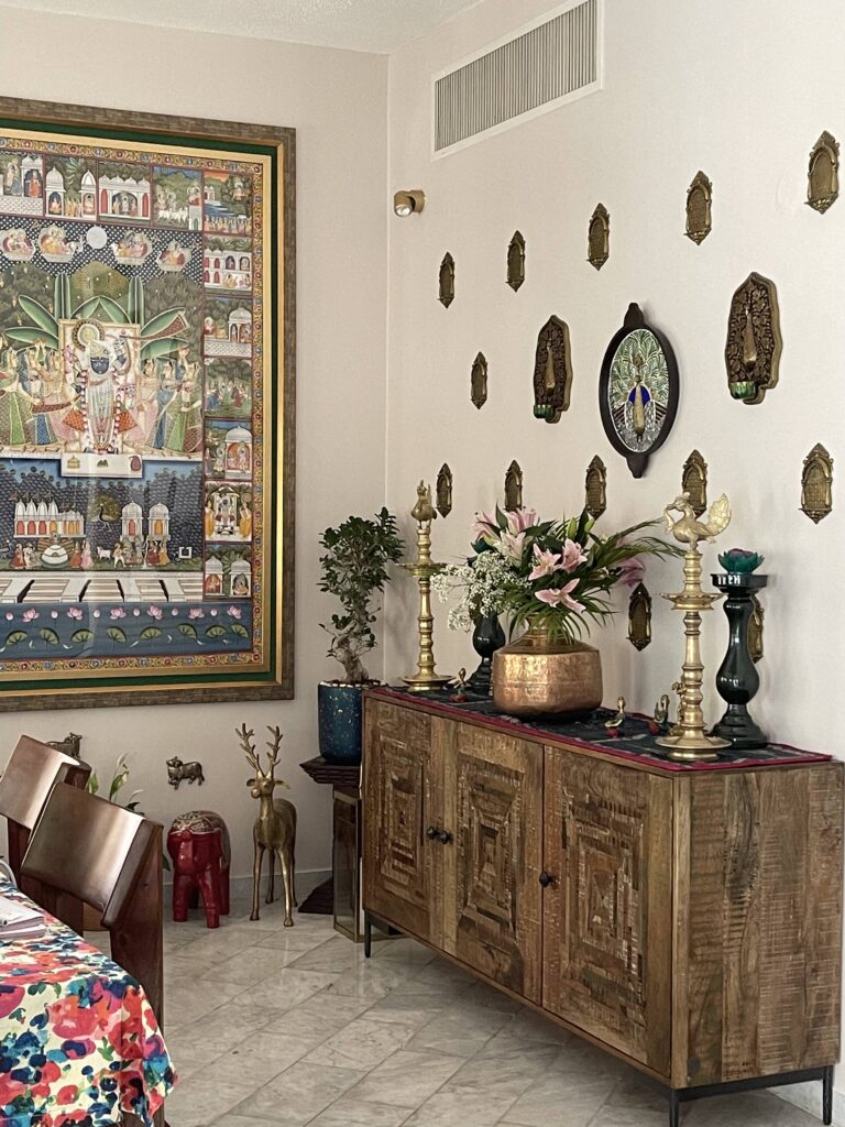 Prameela Nair's Art-Infused Home Abudhabi | Pichwai Wall art painting and brass artifacts decorated at the living room