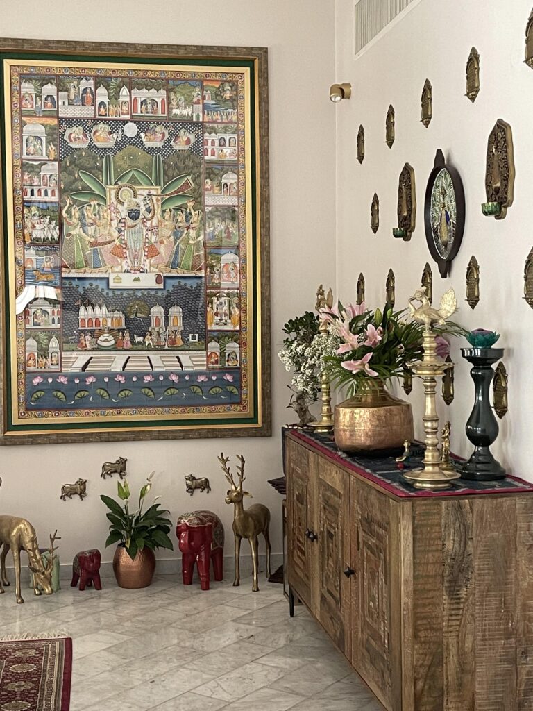 Prameela Nair's Art-Infused Home Abudhabi | Brass collection and pichwai painting in Prameela's living space