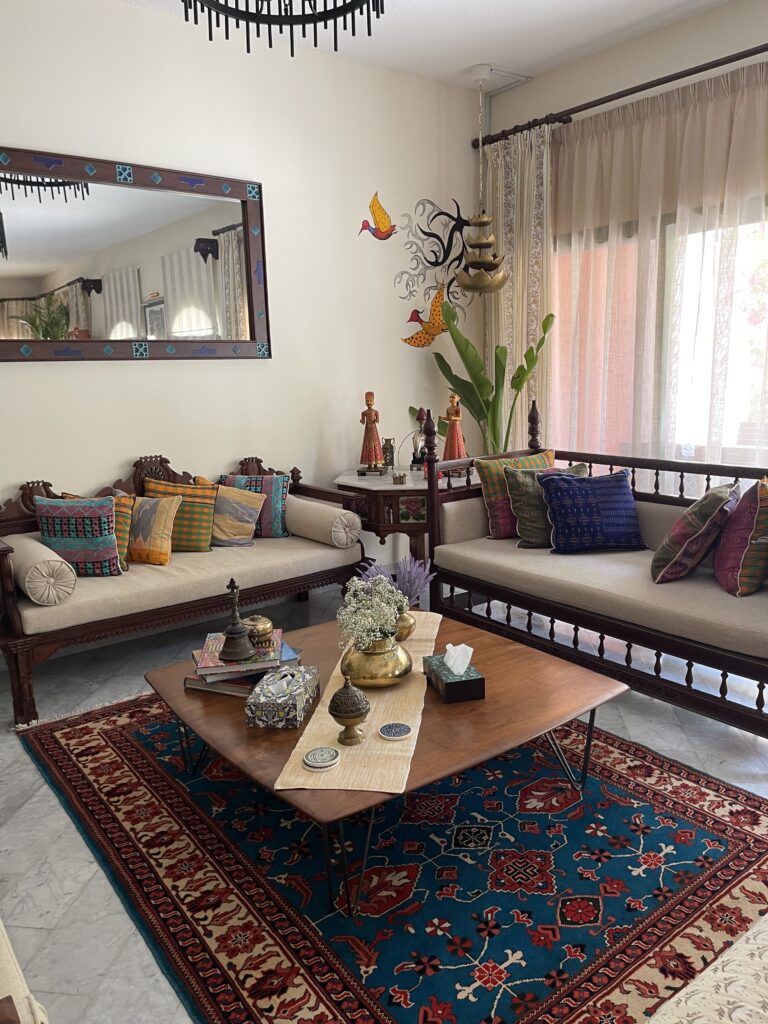 Prameela Nair's Art-Infused Home Abudhabi | Hand painted birds wall art and traditional indian style living room