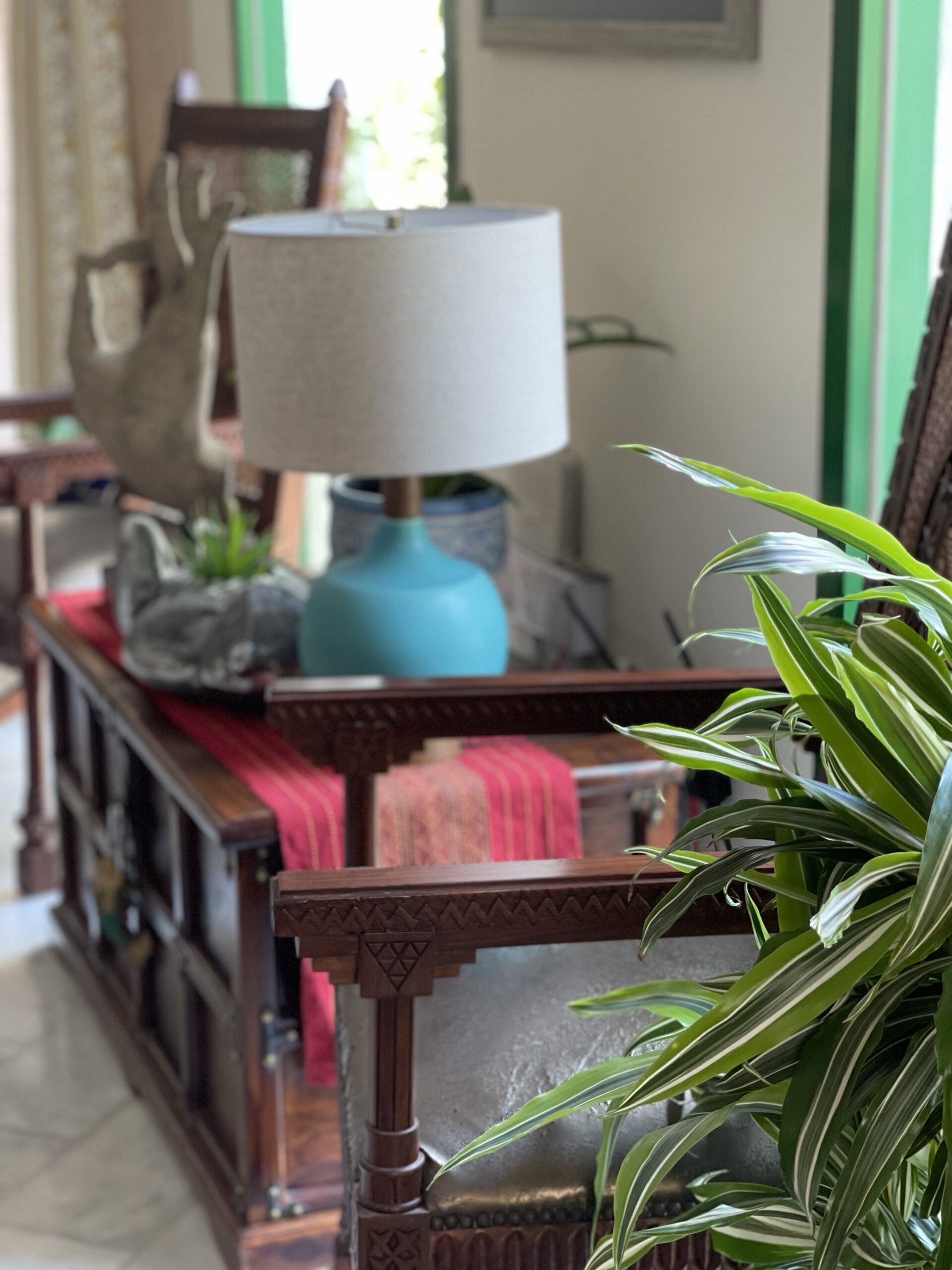 Prameela Nair's Art-Infused Home Abudhabi | Antique wooden trunk and chair at the corner of the living room