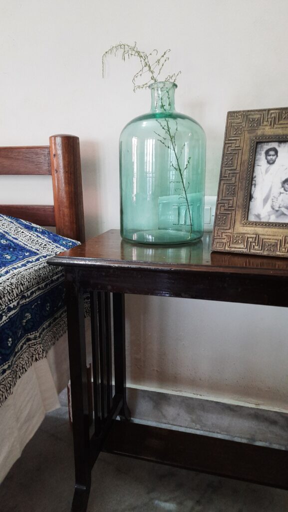 Demijohns in Indian Decor | Vintage large green demijohn on bedside table