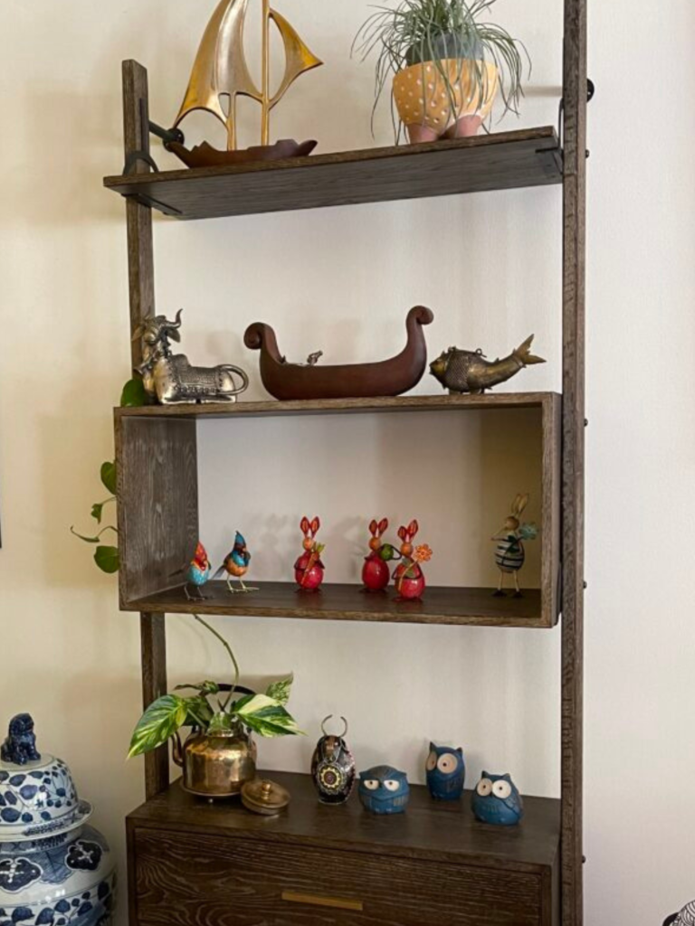 Prameela Nair's Art-Infused Home Abudhabi | Artifacts placed on wooden shelf