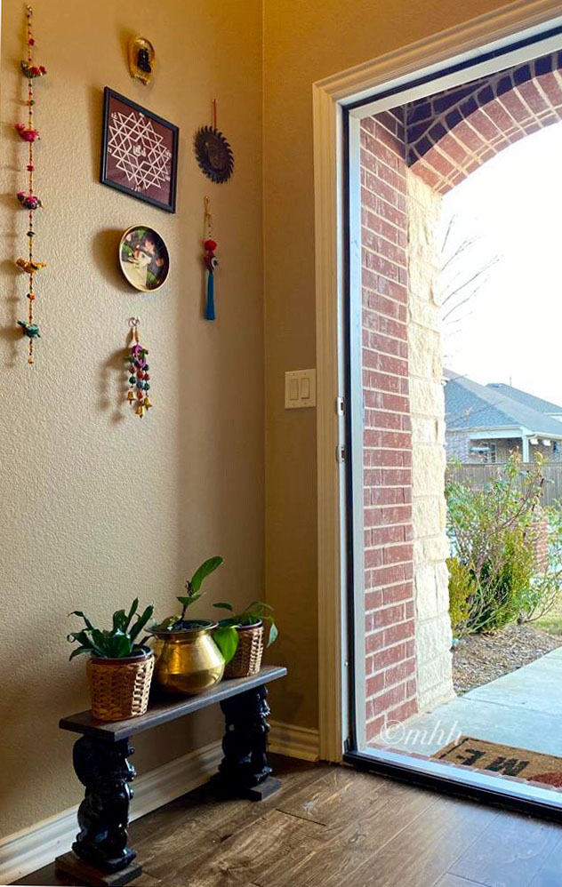 Home tour of Meena Harish | Kolam/Rangoli sticker frame from the dollar store and a Pichwai cow painting from a boutique seller in the entryway wall