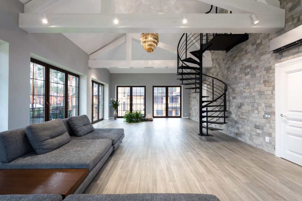 Sitting room with grey sofas with black accents of a large view window | Black windows in decor