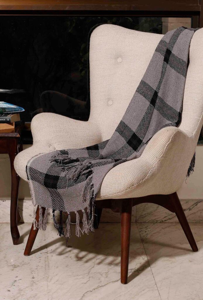 The beautiful grey throw, which is innately stylish and hand woven | Women artisans brand in India