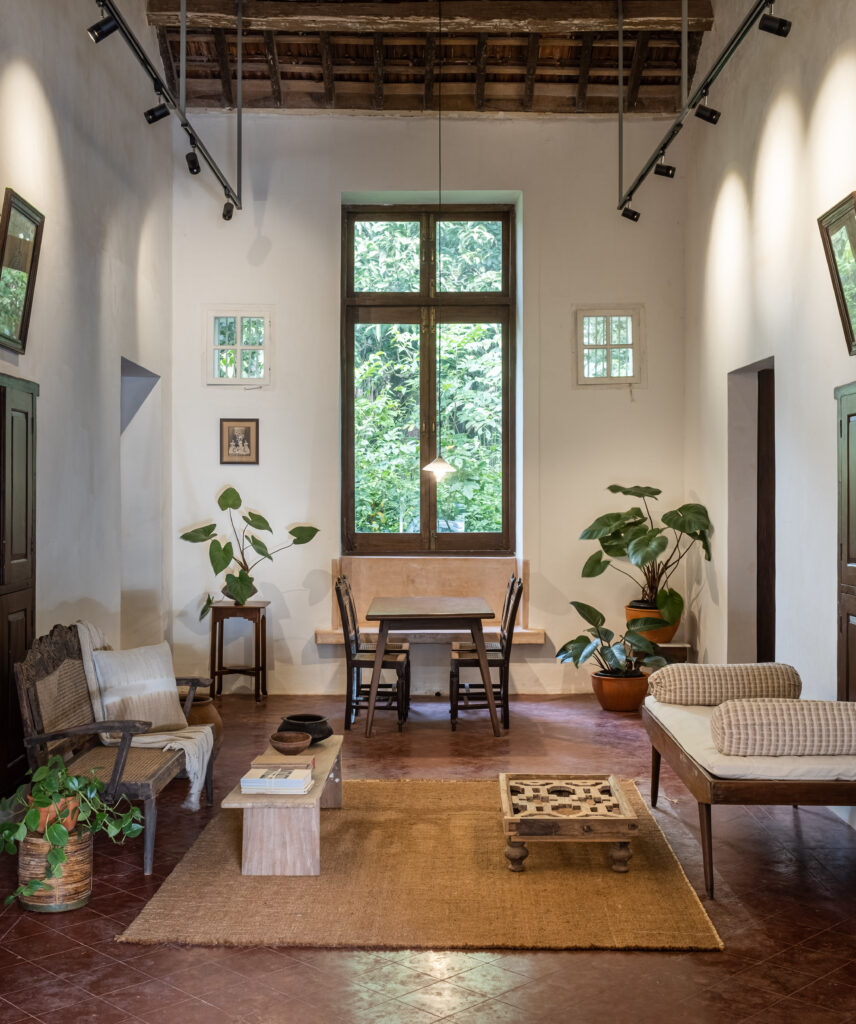 Transforming a niche into a long window in the living room bringing in light and which now frames an outdoor tree beautifully |