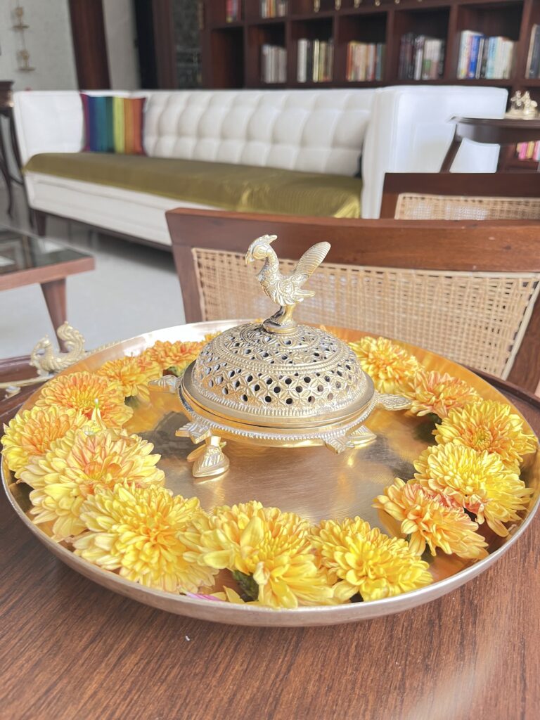 Brass parrot dhupdani and urli plate on the table | Ranjana and Milind's apartment in Pune