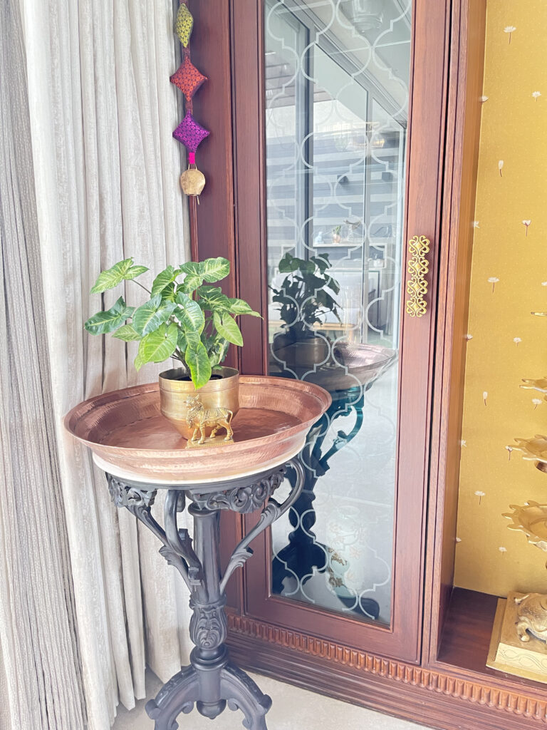 Plant stand for indoor and outdoor plants with brass collection | Ranjana and Milind's apartment in Pune