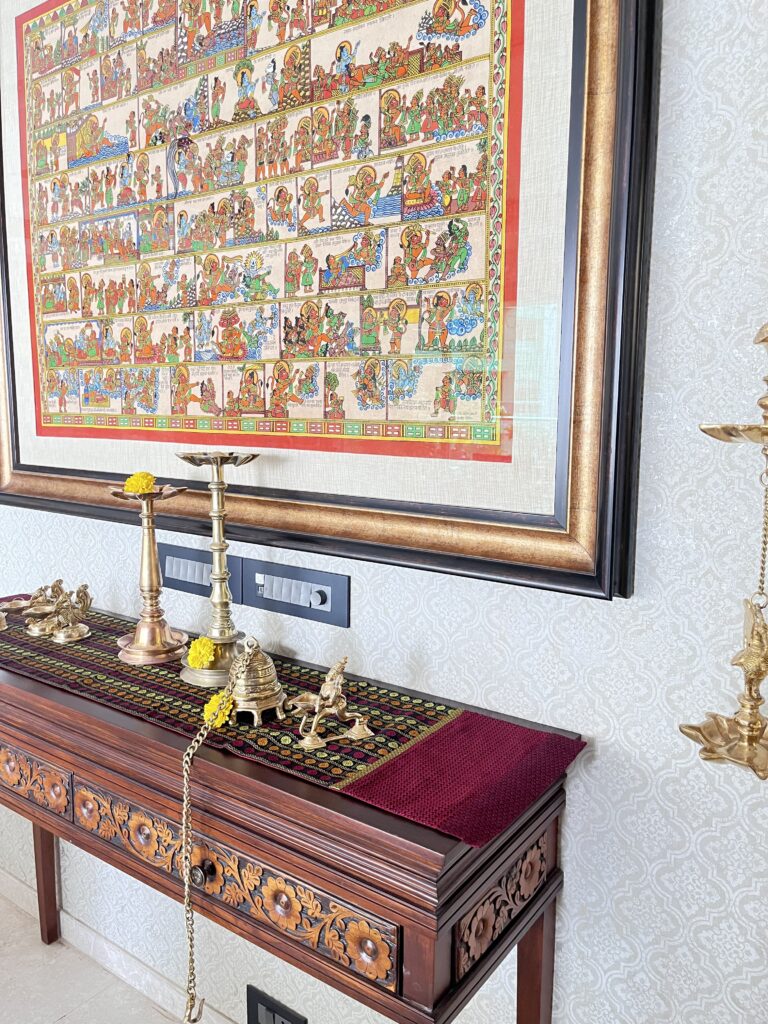Console table with brass collection and wall art frame | Ranjana and Milind's apartment in Pune