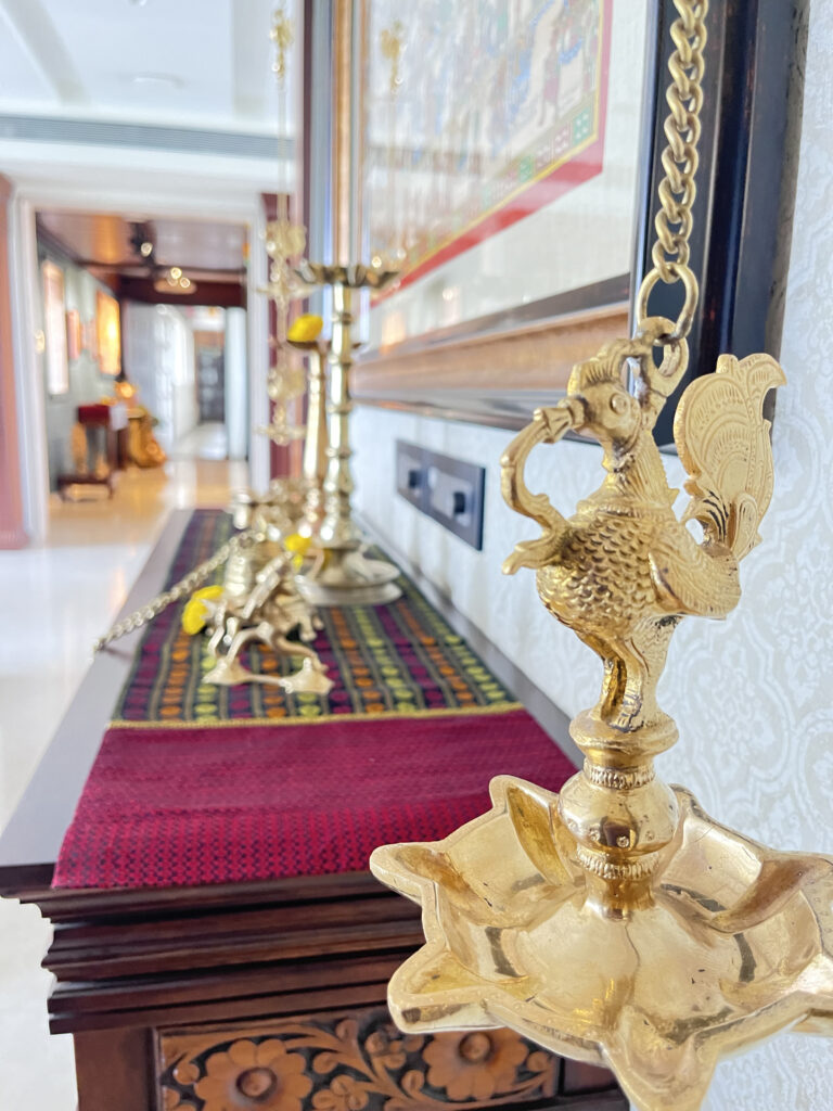 Antique brass peacock hanging diya at the corner of the room | Ranjana and Milind's apartment in Pune