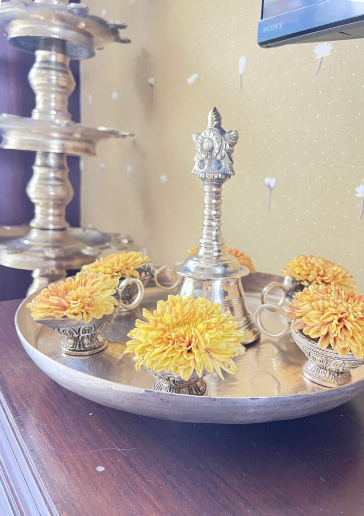 Traditional diyas with merigold flower on urli puja plate | Ranjana and Milind's apartment in Pune
