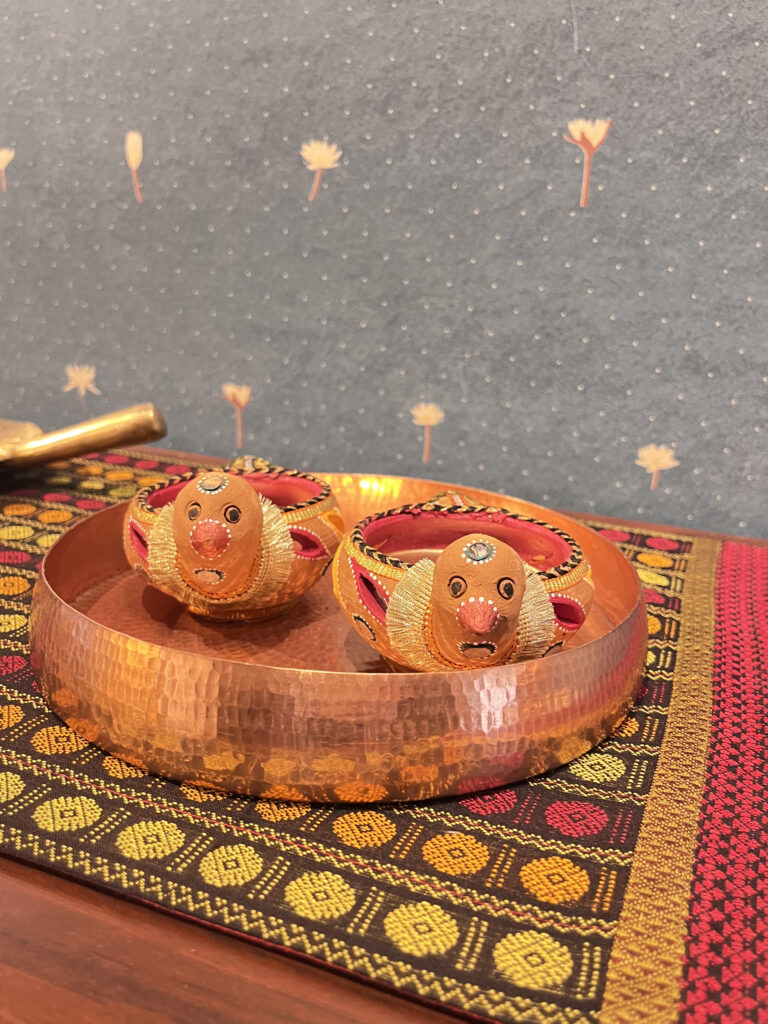 Unique bird diya with urli plate on table | Ranjana and Milind's apartment in Pune
