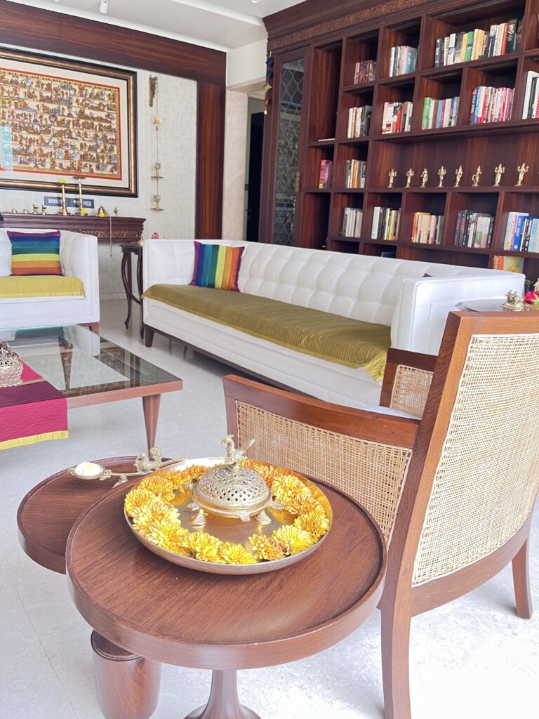 Brass parrot dhupdani with urli plate and brass aarti diya on the table at the living room | Ranjana and Milind's apartment in Pune