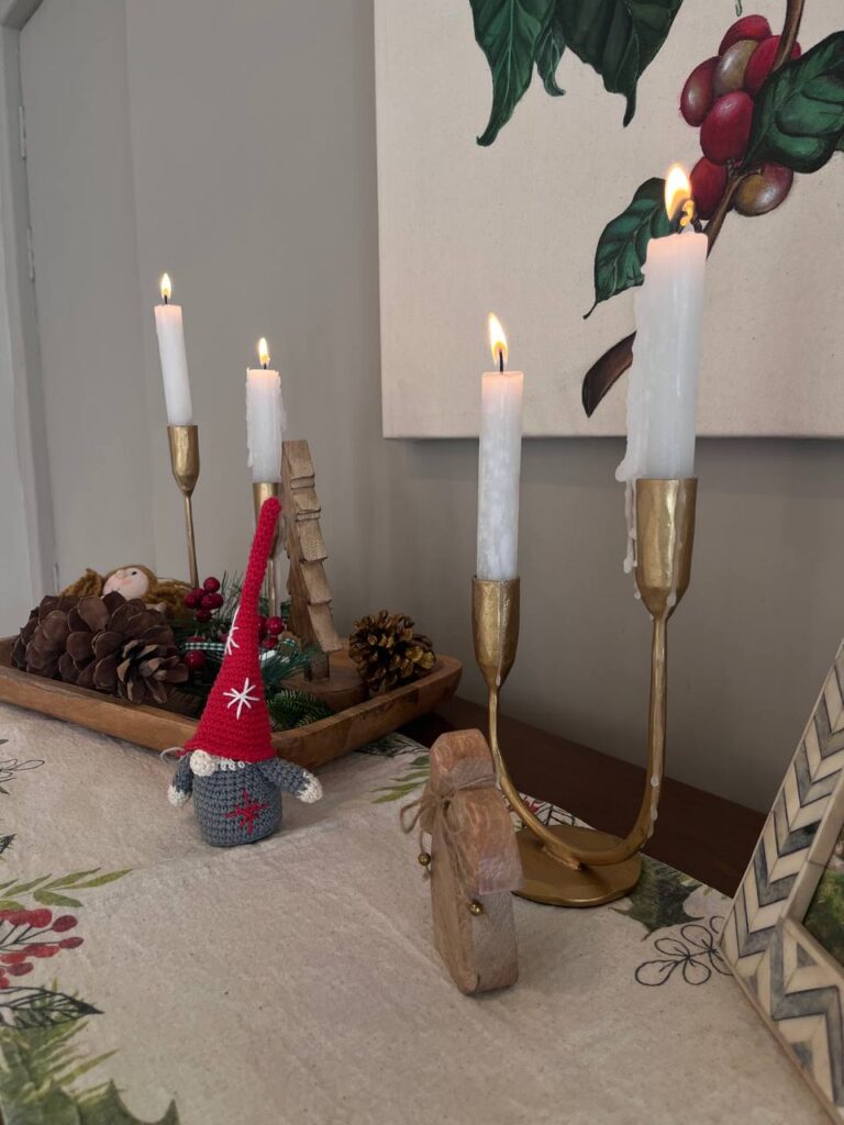 the sideboard houses a doughbowl decorated for christmas with other christmas elements